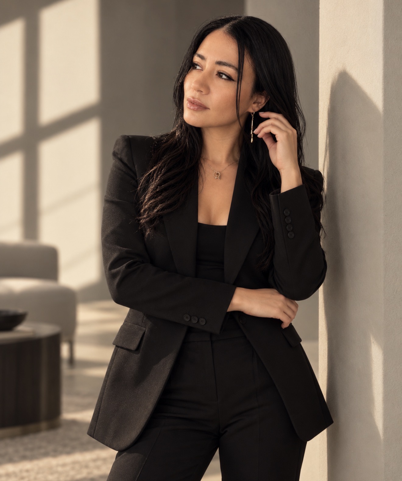Natali Constante in a black suit